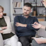 Mediator discussing solutions with husband and wife
